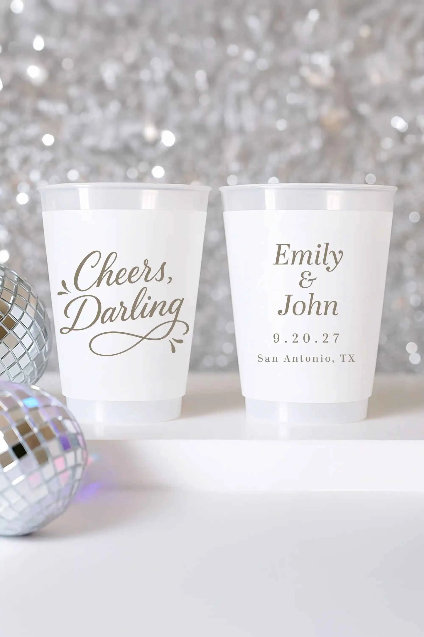 Personalized wedding cups featuring gold 'Cheers, Darling' design customized with couple’s names and wedding date, ideal for elegant fun receptions.