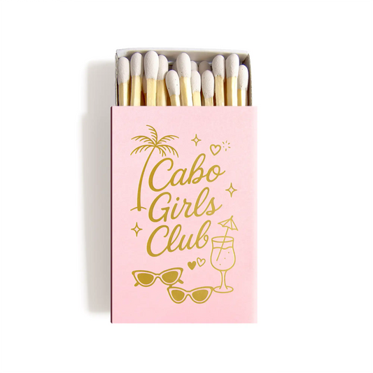 Matchbox with 'Cabo Girls Club' text and palm tree design on a pink background