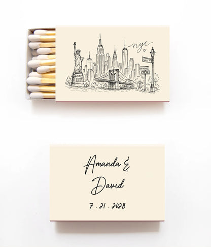 Personalized matchbox set on a white background, featuring a top matchbox with a New York City skyline illustration and the text 'Amanda & David 7.21.