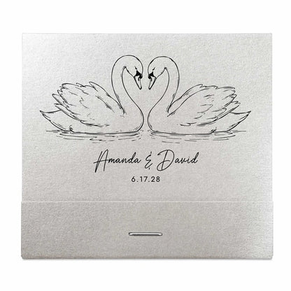 Silver matchbook with engraved swans and personalized text on a white background