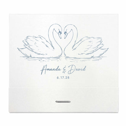 Two swans facing each other with personalized names and date on a white matchbook and background