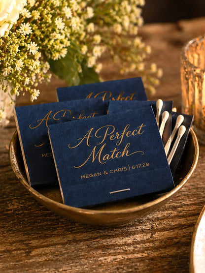 Navy blue cards with gold text 'A Perfect Match' in a bowl on a wooden surface.