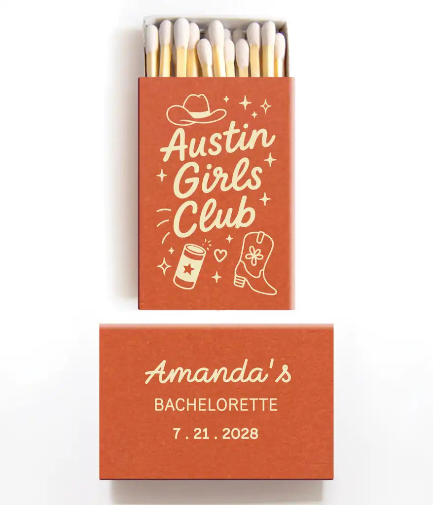 Orange and ivory matchbox with 'Austin Girls Club' design and 'Amanda's Bachelorette' text on a white background