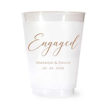 White cup with brown 'Engaged' text and personalized names and date on a white background