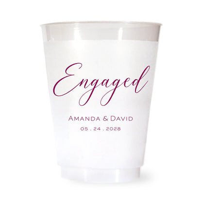 White plastic cup with burgundy 'Engaged' text and personalized names and date on a white background