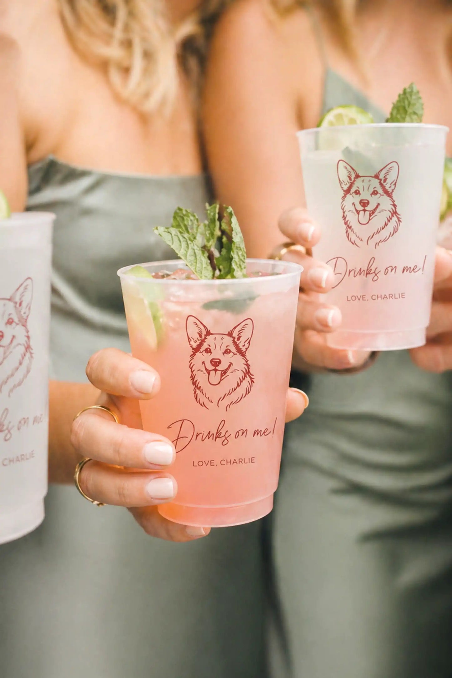 Two people holding pink drinks in cups with a corgi dog illustration and text.