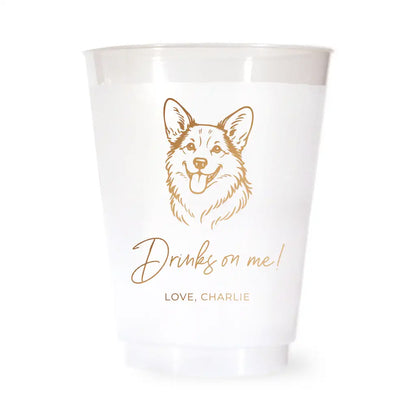 White cup with a corgi dog illustration and text 'Drinks on me! Love, Charlie' on a white background