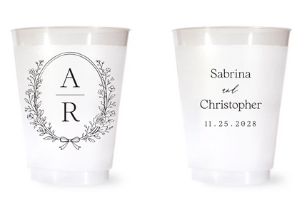 Two white cups with personalized designs on a white background
