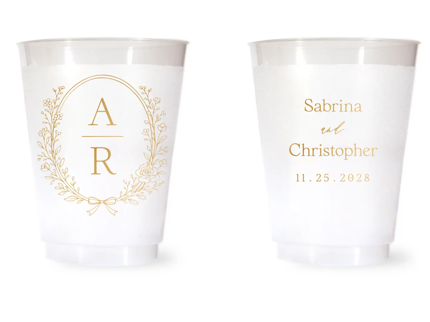 Two white cups with gold monogram and personalized text on a white background