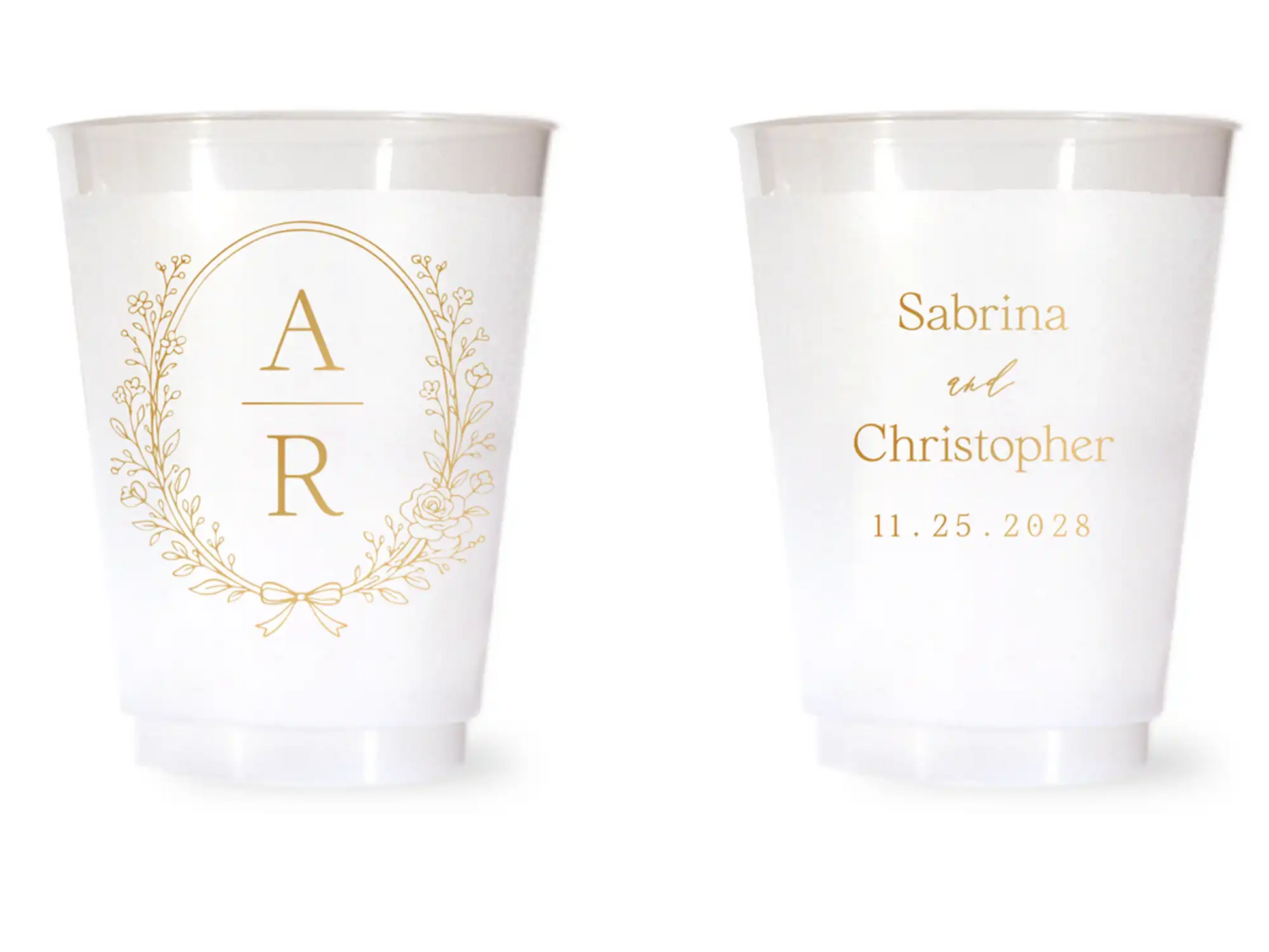 Two white cups with gold monogram and personalized text on a white background