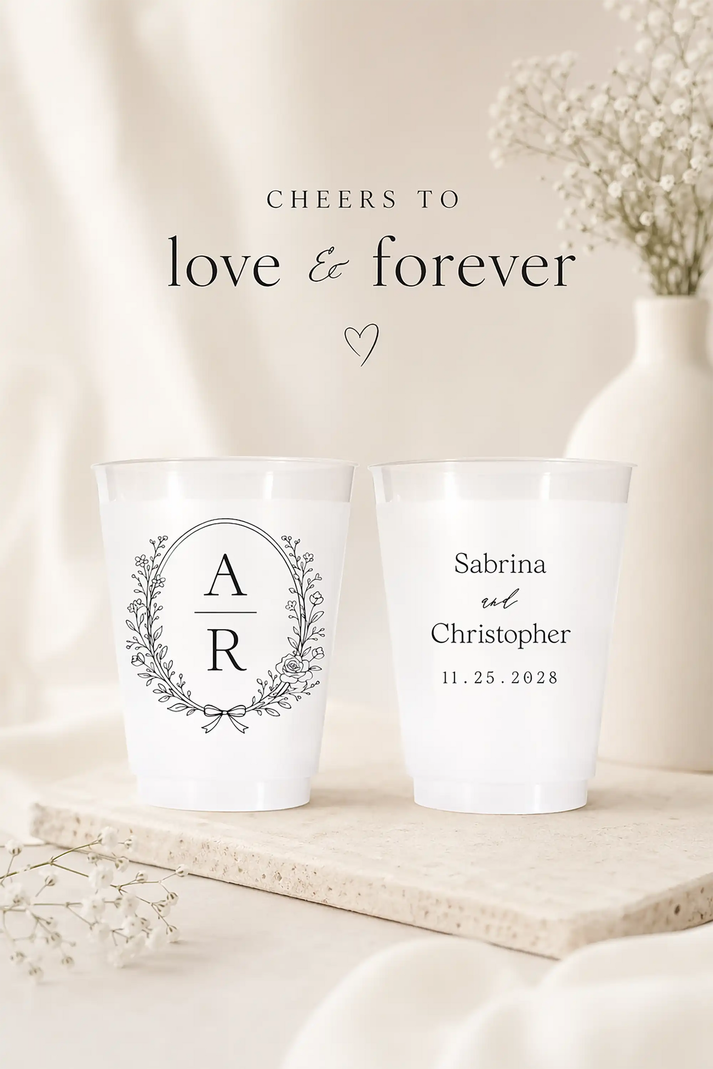 Two personalized cups with monogram and names on a neutral background