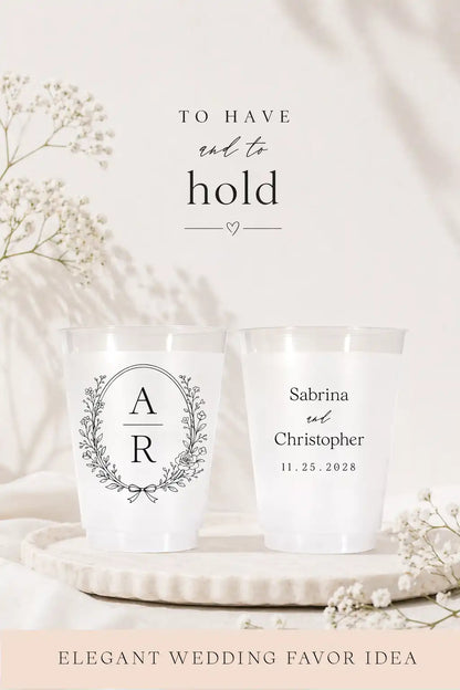 Two personalized cups on a decorative plate with floral elements, featuring text 'To have and to hold' and 'Elegant Wedding Favor Idea'.
