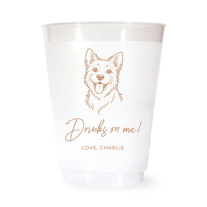 White cup with a brown terrier dog illustration and drinks on me love charlie text on a white background