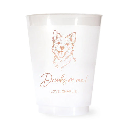 White cup with a terrier dog illustration and drinks on me love charlie text in rose gold on a white background