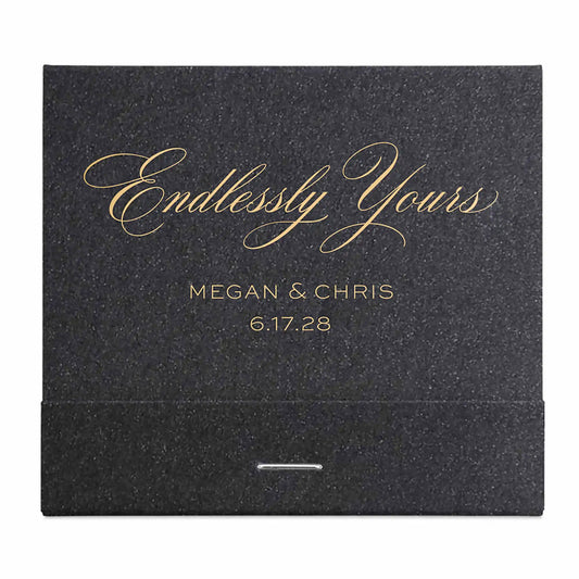 Black wedding matchbook with 'Endlessly Yours' and personalized text in gold on a white background