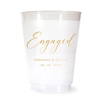 White plastic cup with 'Engaged' and personalized text in gold on a white background