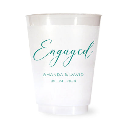 White plastic cup with green 'Engaged' text and personalized names and date on a white background