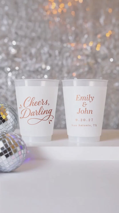 cheers darling personalized wedding cups on a white table with silver decor and disco balls.