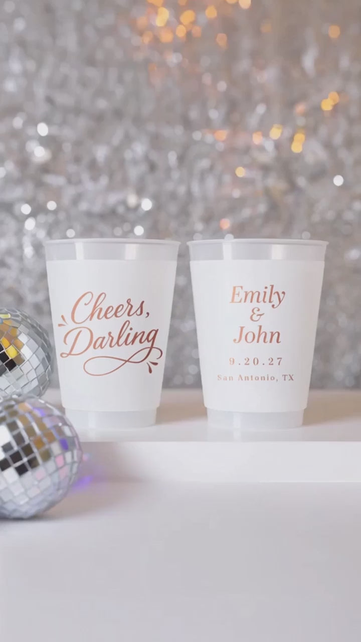 cheers darling personalized wedding cups on a white table with silver decor and disco balls.