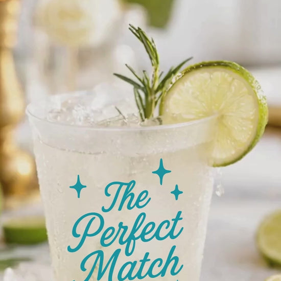 The perfect match cups with a refreshing drink and rosemary spring and lime wedge on a wedding table. text overlay says Your signature Wedding Drink.